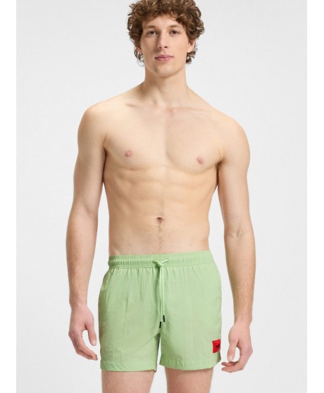 Fully lined swim shorts with red logo label